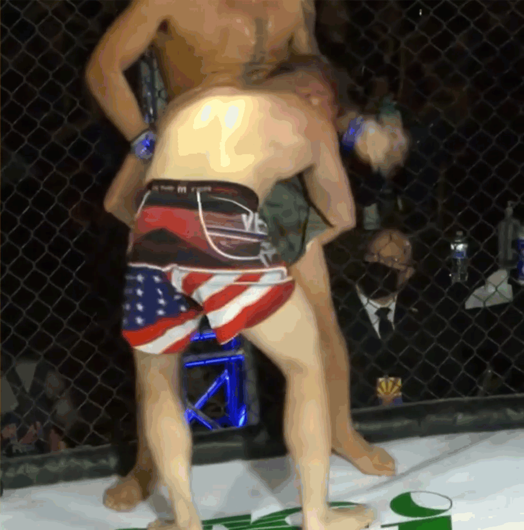 Pressing against the cage and stepping his leg over